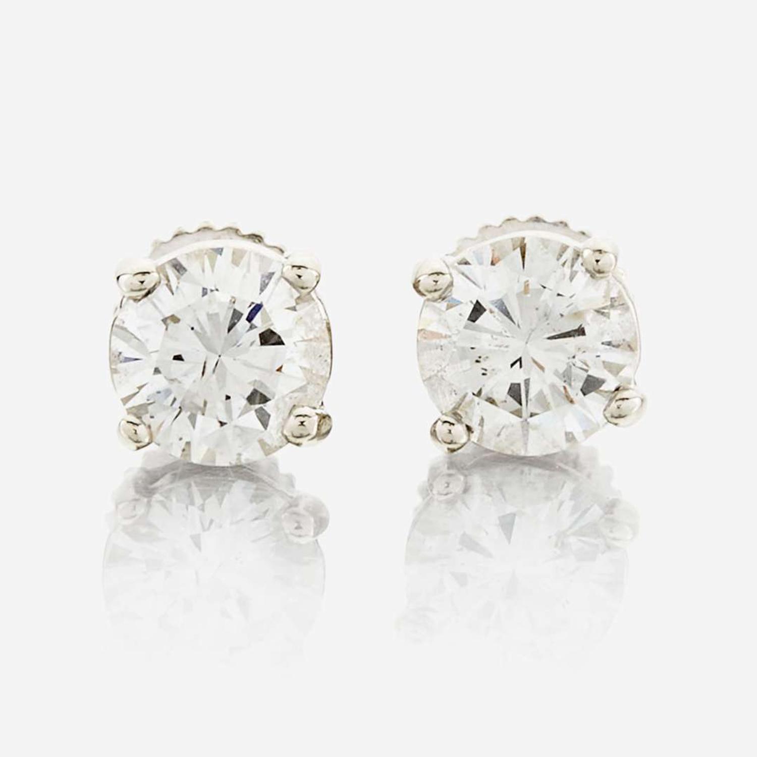 A pair of diamond and white metal earrings