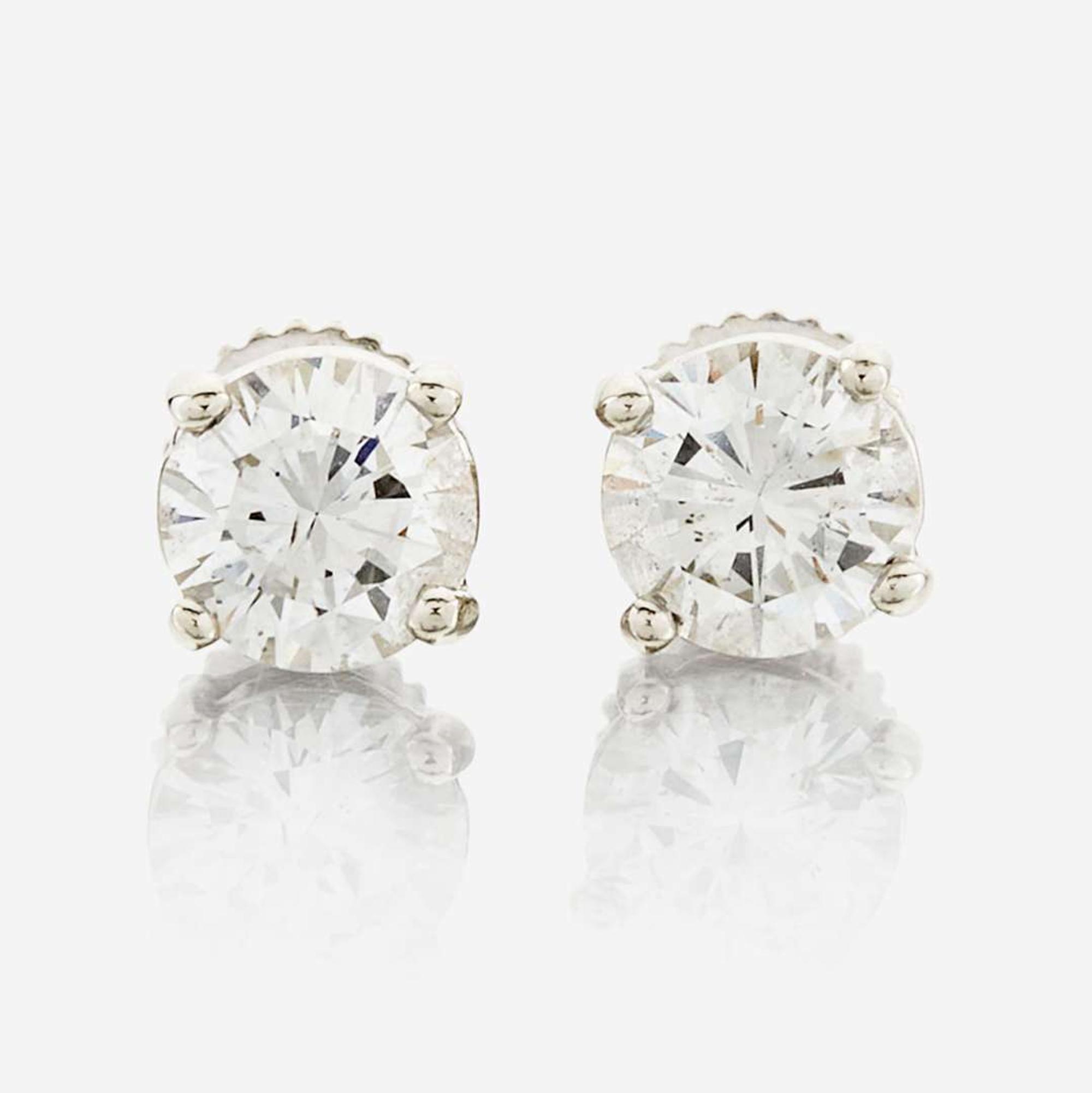 A pair of diamond and white metal earrings