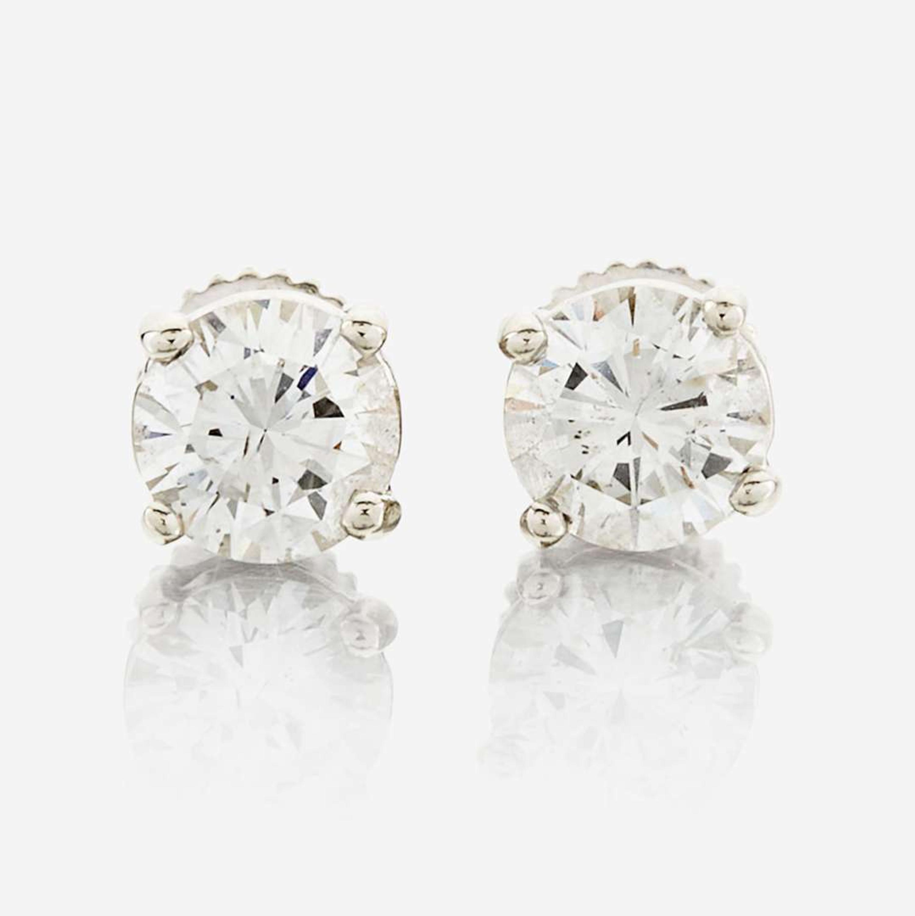 A pair of diamond and white metal earrings