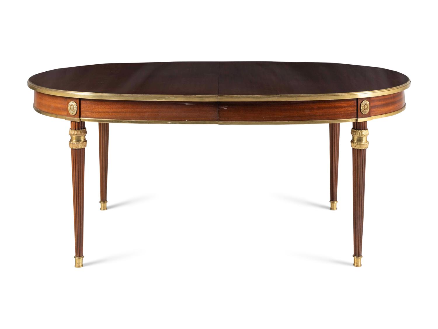 A Louis XVI Style Gilt Bronze Mounted Mahogany Dining Table