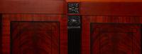 A Late Regency Style Figured Mahogany Sideboard with Carved Ebonized Pilasters