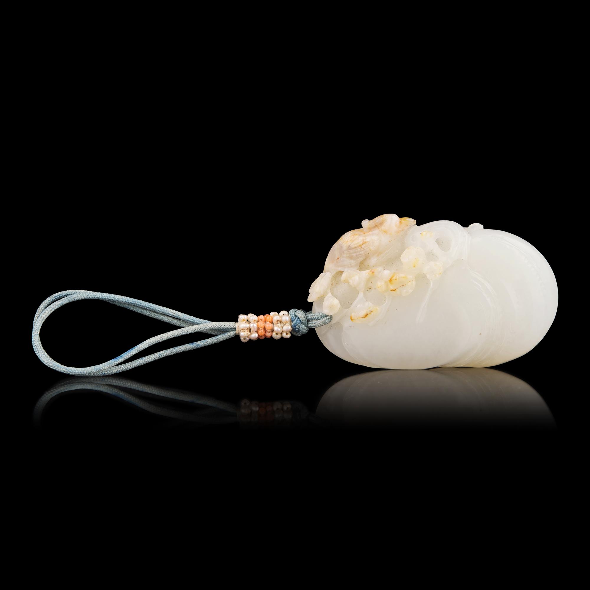 A Chinese Russet and White Jade 'Bird on Prunus' Pendant, Possibly 18th Century 或清中期 梅雀爭春巧雕玉珮