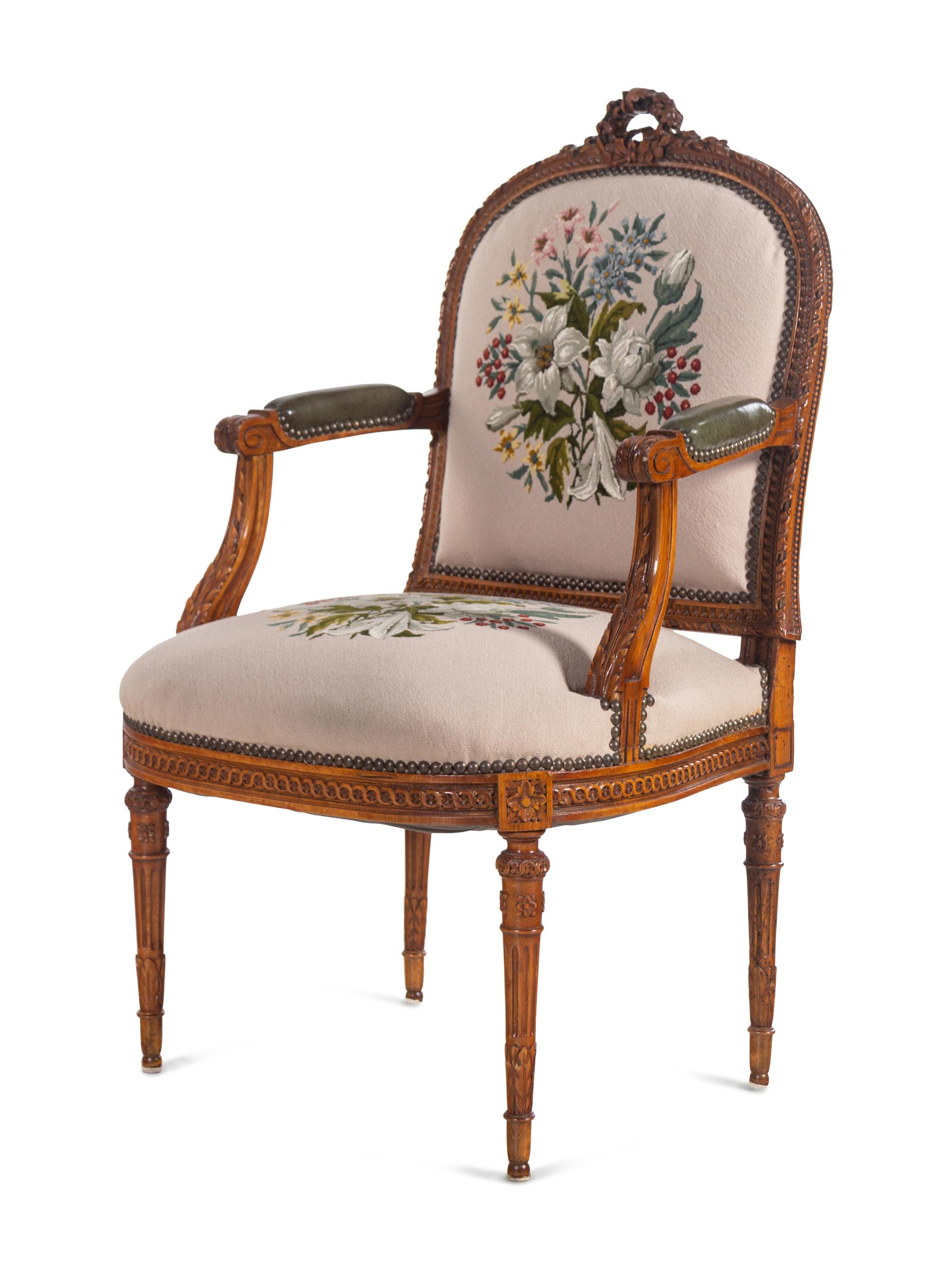 A Louis XVI Carved Walnut Seating Suite with Petit Point Upholstery