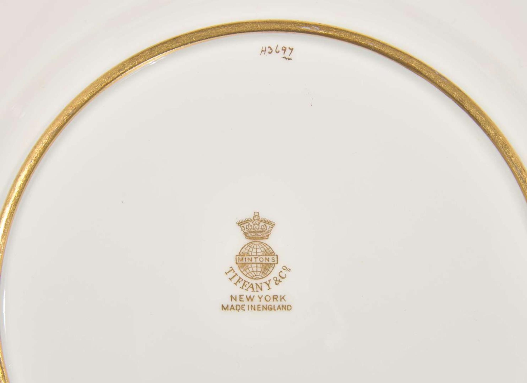 A set of twelve pate-sur-pate gilt and enameled porcelain luncheon plates, Minton, England, retailed by Tiffany & Co., New York, NY, date marks for 1928-1929