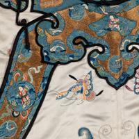 A Chinese Pale Blue Ground Embroidered Silk 'Butterfly' Lady's Informal Robe, Late Qing/Republic Period 晚清/民國 月白緞地百蝶紋女襖
