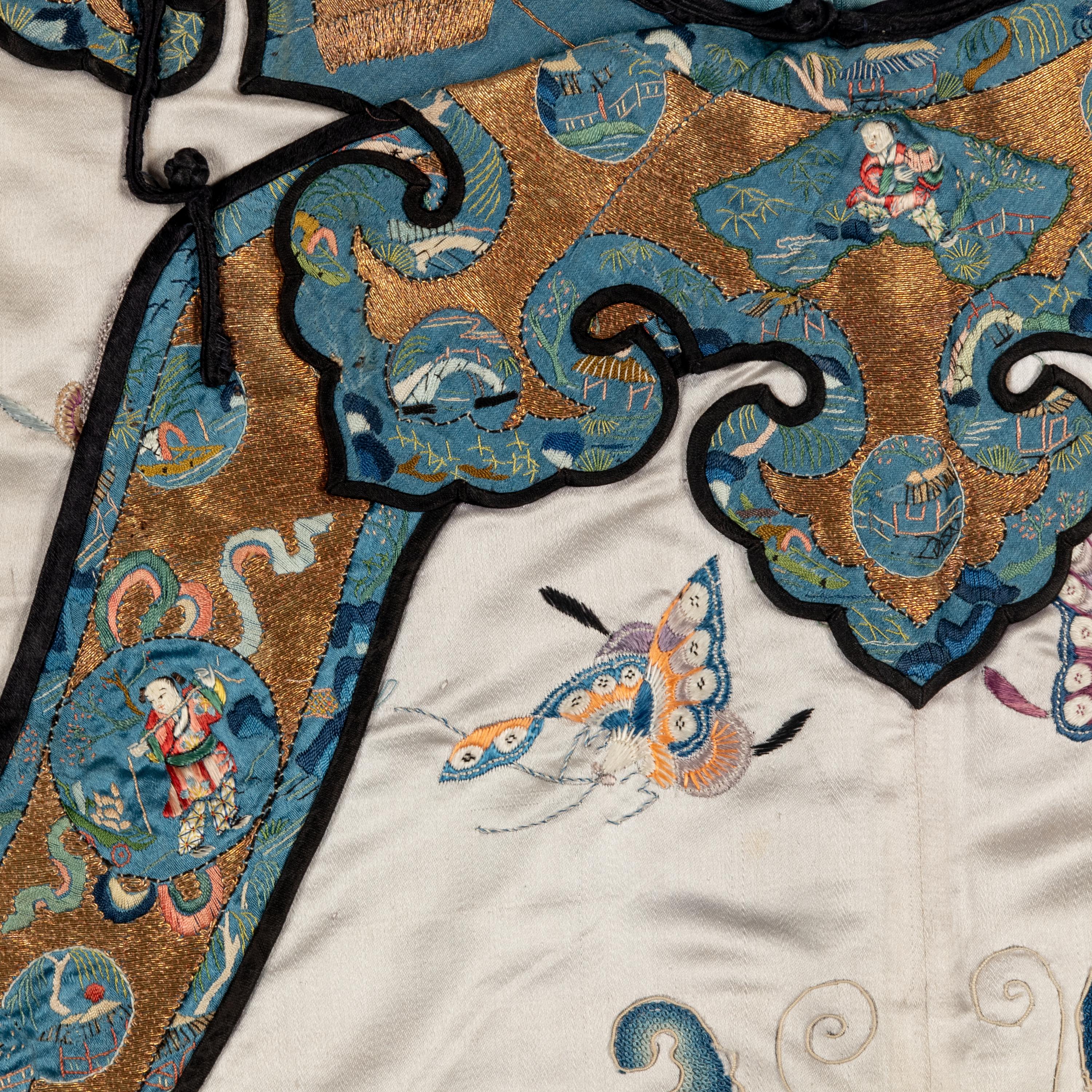 A Chinese Pale Blue Ground Embroidered Silk 'Butterfly' Lady's Informal Robe, Late Qing/Republic Period 晚清/民國 月白緞地百蝶紋女襖