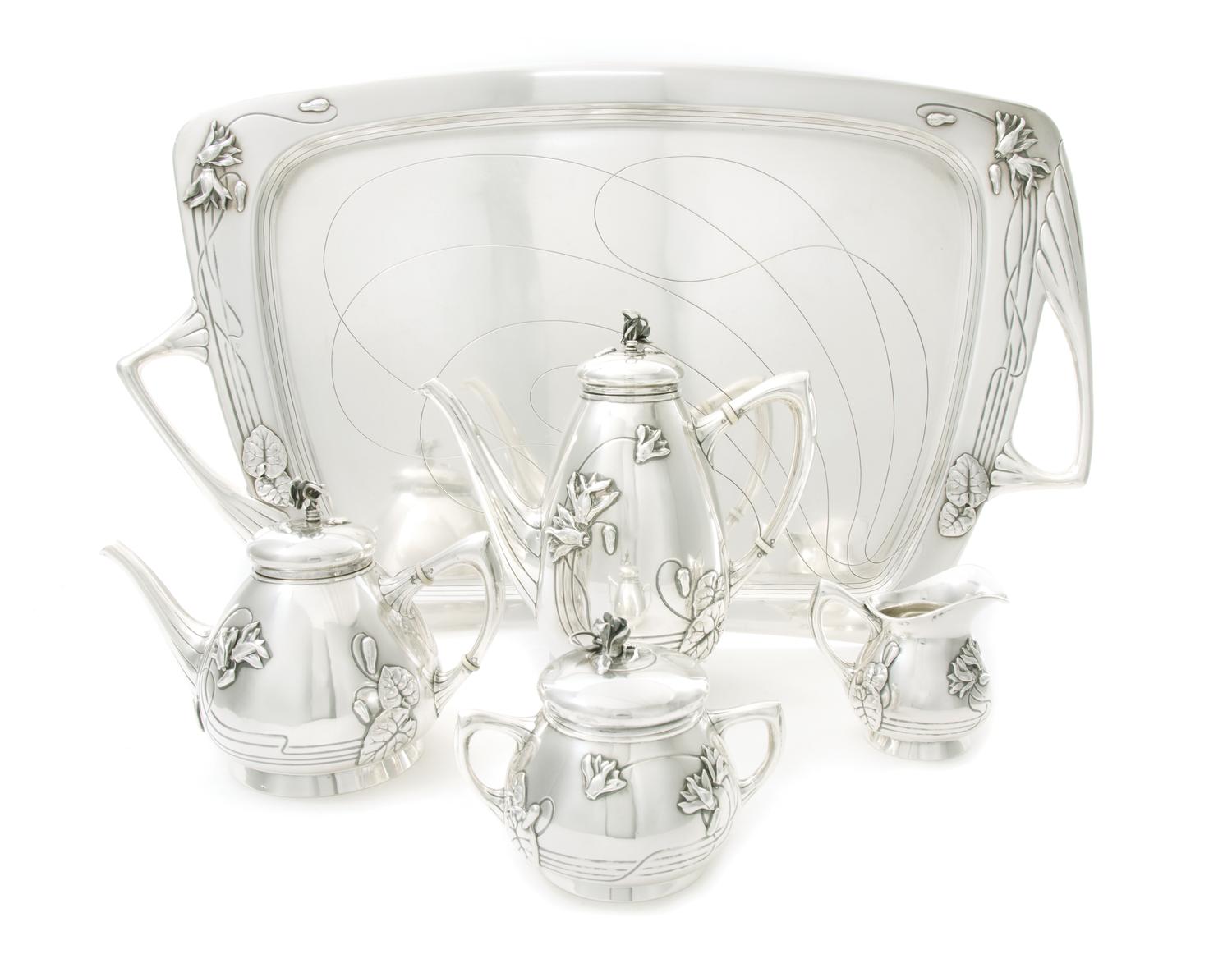 An Austrian Art Nouveau Silver Tea and Coffee Service, CIRCA 1900, comprising a coffee pot, a teapot, a covered sugar, a creamer and a