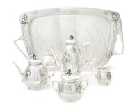 An Austrian Art Nouveau Silver Tea and Coffee Service, CIRCA 1900, comprising a coffee pot, a teapot, a covered sugar, a creamer and a