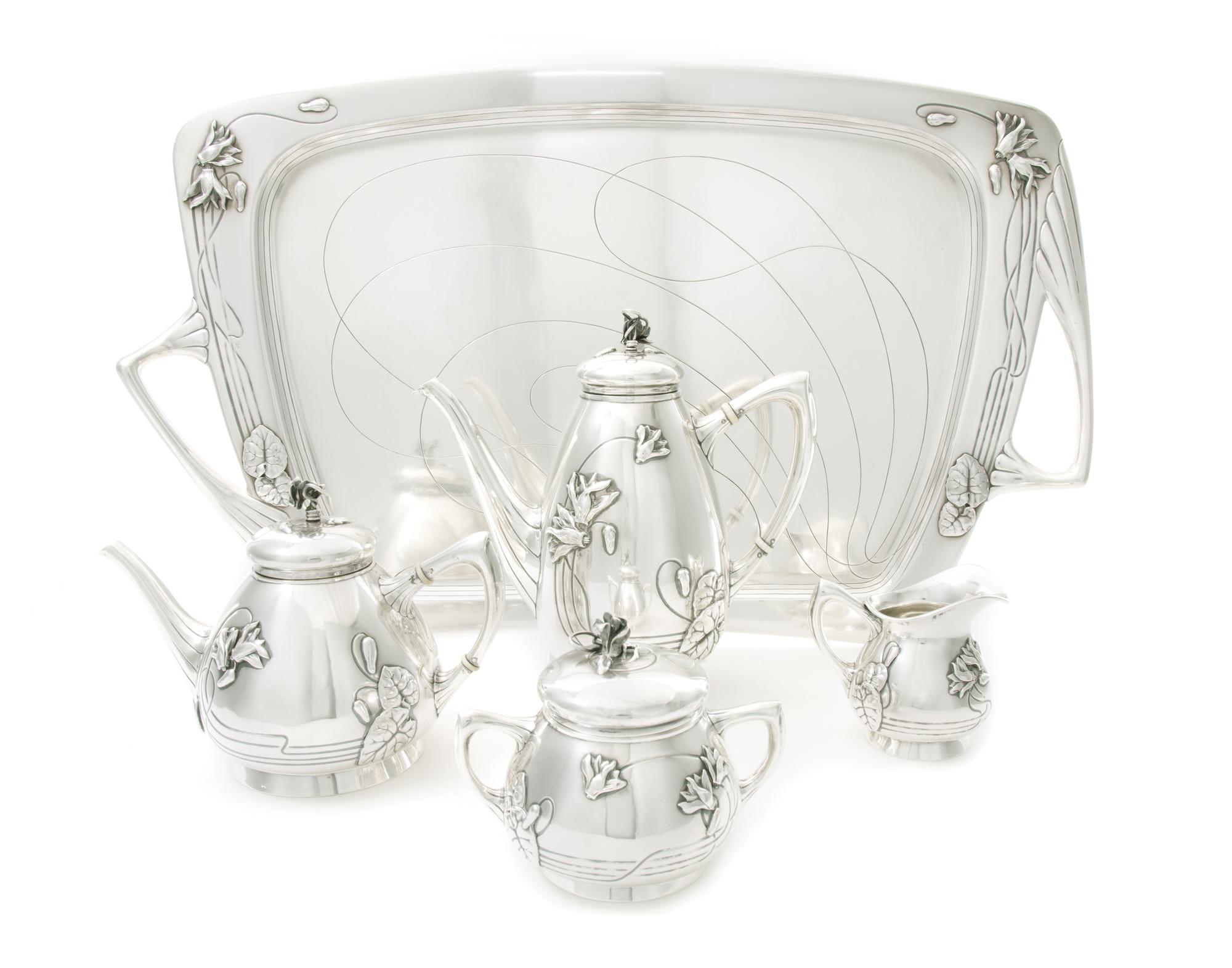 An Austrian Art Nouveau Silver Tea and Coffee Service, CIRCA 1900, comprising a coffee pot, a teapot, a covered sugar, a creamer and a