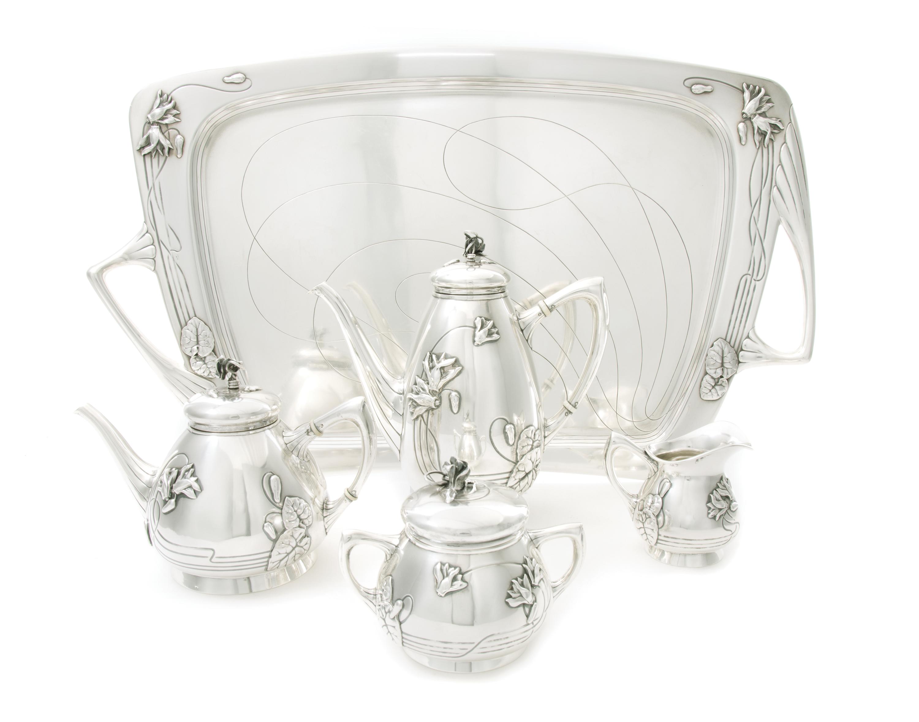 An Austrian Art Nouveau Silver Tea and Coffee Service, CIRCA 1900, comprising a coffee pot, a teapot, a covered sugar, a creamer and a