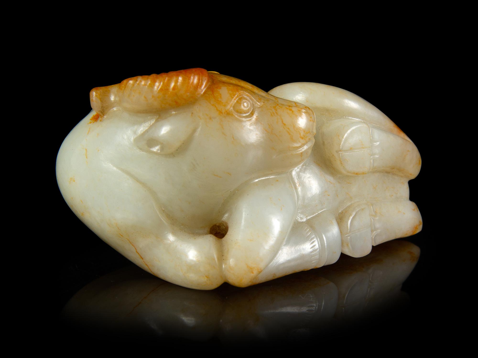 A Russet and White Jade Figure of a Buffalo