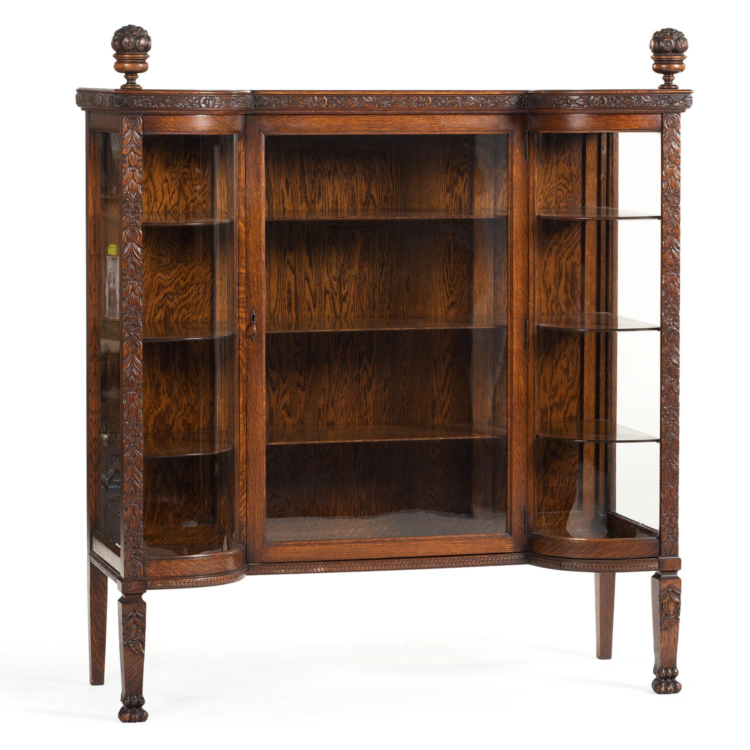 A Carved Oak Vitrine Cabinet and Open Bookshelf