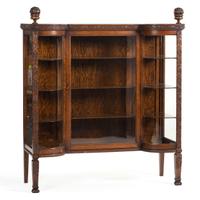 A Carved Oak Vitrine Cabinet and Open Bookshelf