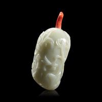 A Chinese Carved Celadon and Russet Jade Snuff Bottle