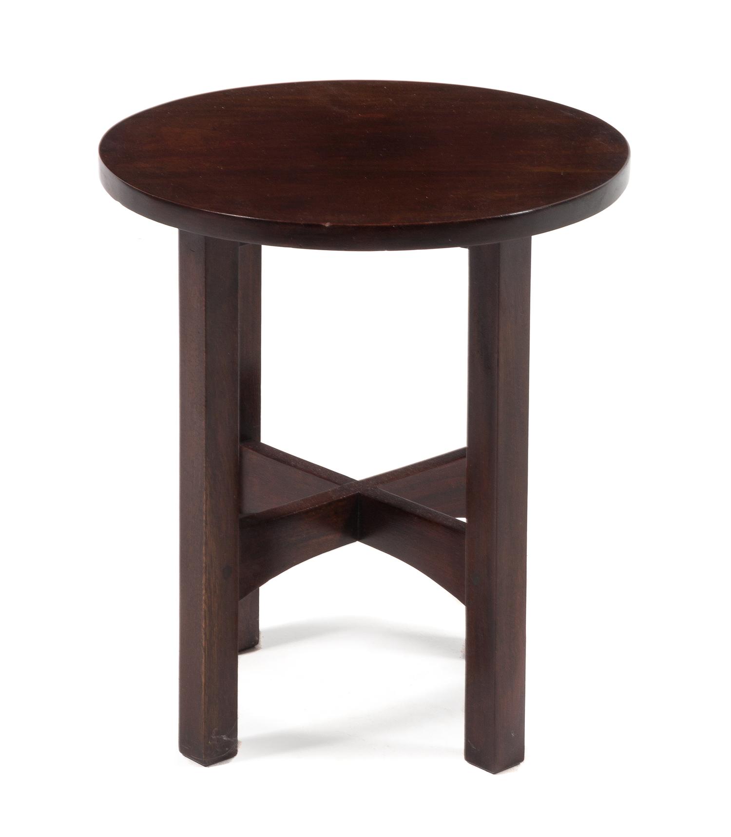 Gustav Stickley, (American, 1858-1942), a mahogany tabouret, model no. 602, having a circular top raised on squared legs joined by stre