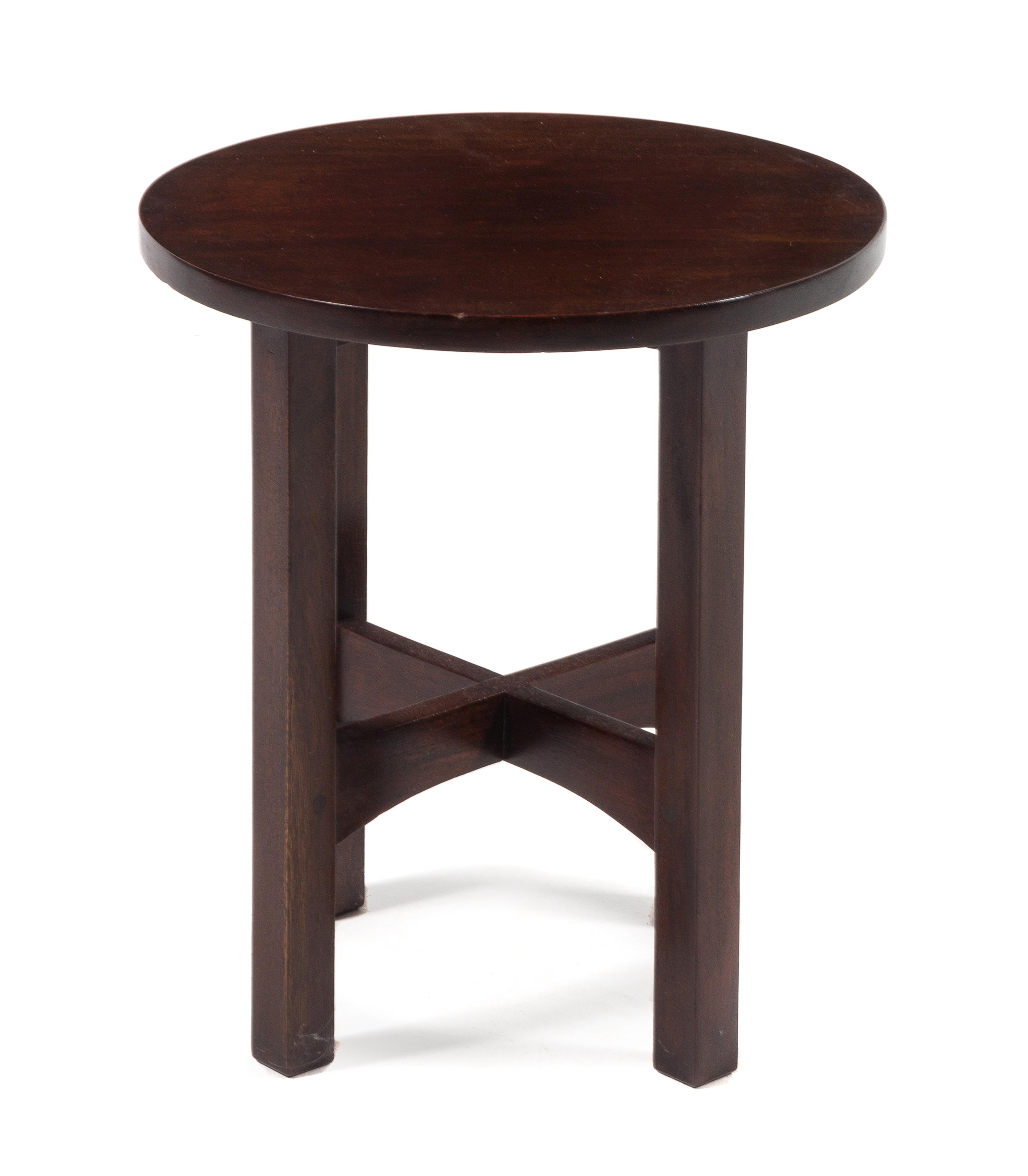 Gustav Stickley, (American, 1858-1942), a mahogany tabouret, model no. 602, having a circular top raised on squared legs joined by stre