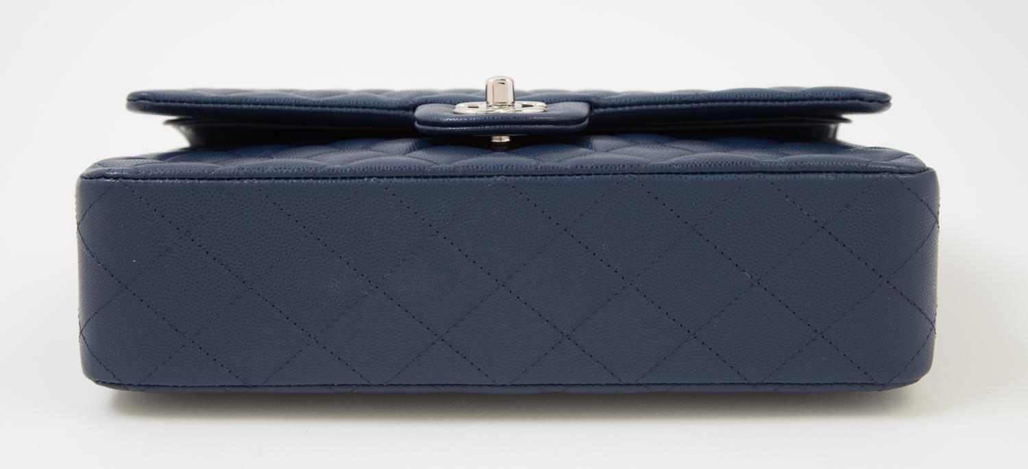 A Chanel Navy Caviar Classic Double Flap Handbag, 10" x 6" x 2.5"; Strap Drop: 9.5".