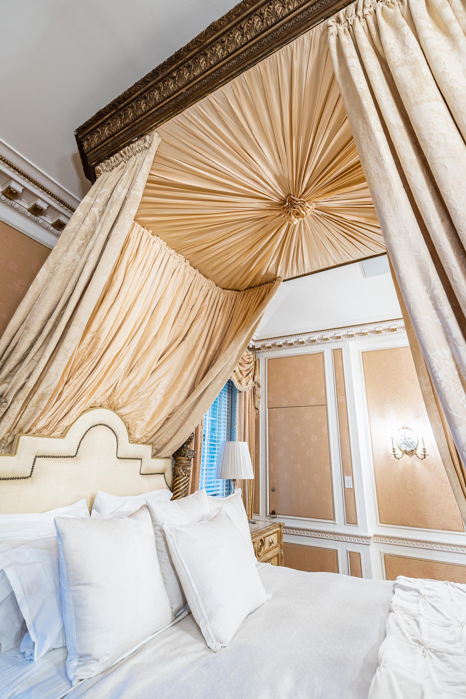 An Italian Carved Giltwood Bedstead with Baldachin, Headboard and Drapes