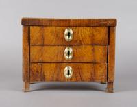 A Burlwood Diminutive Chest of Drawers, Height 8 1/4 inches.