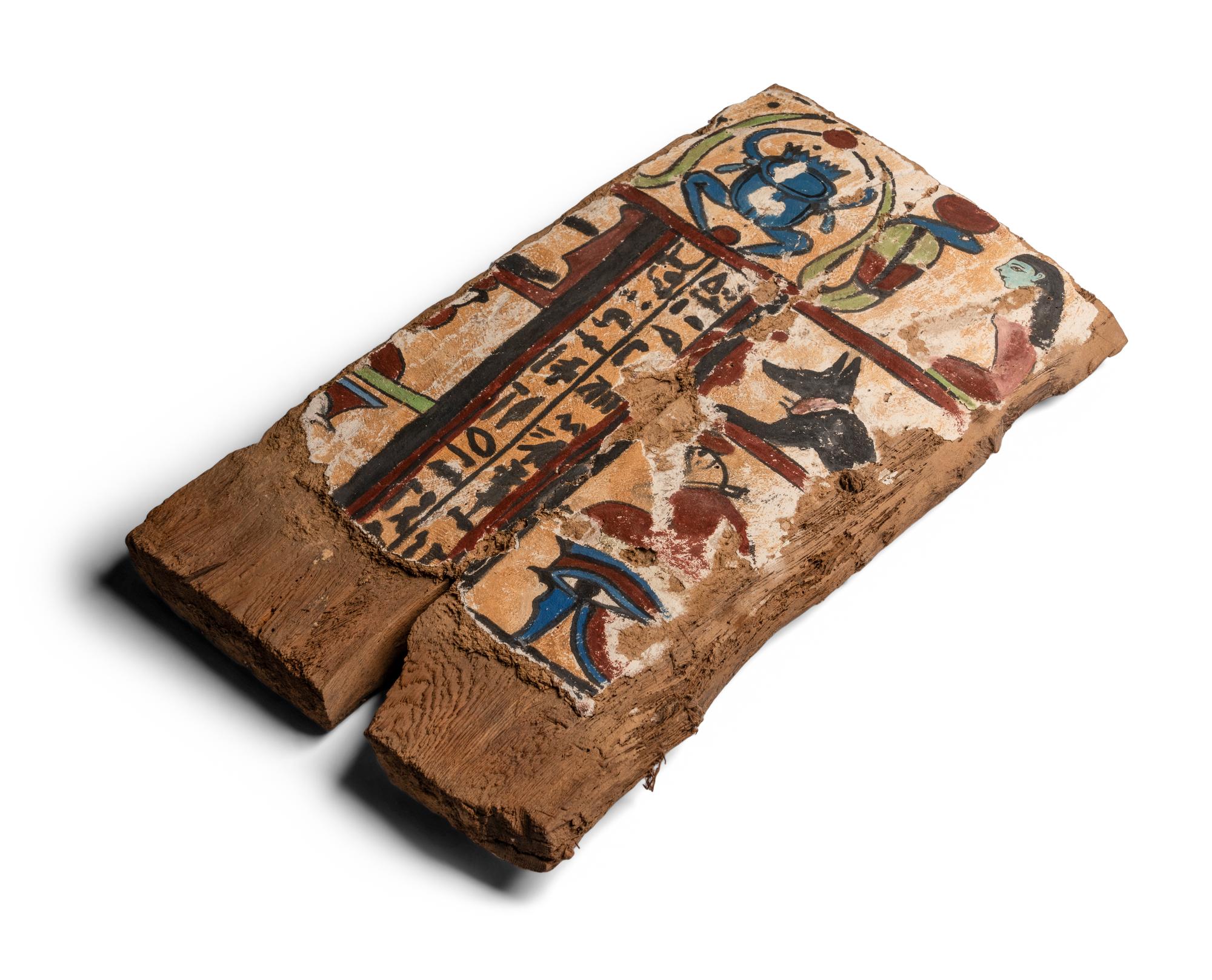 An Egyptian Painted Wood Sarcophagus Fragment with a Scarab