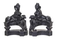 A Pair of English Cast Iron Chenets, Height 21 1/4 inches.