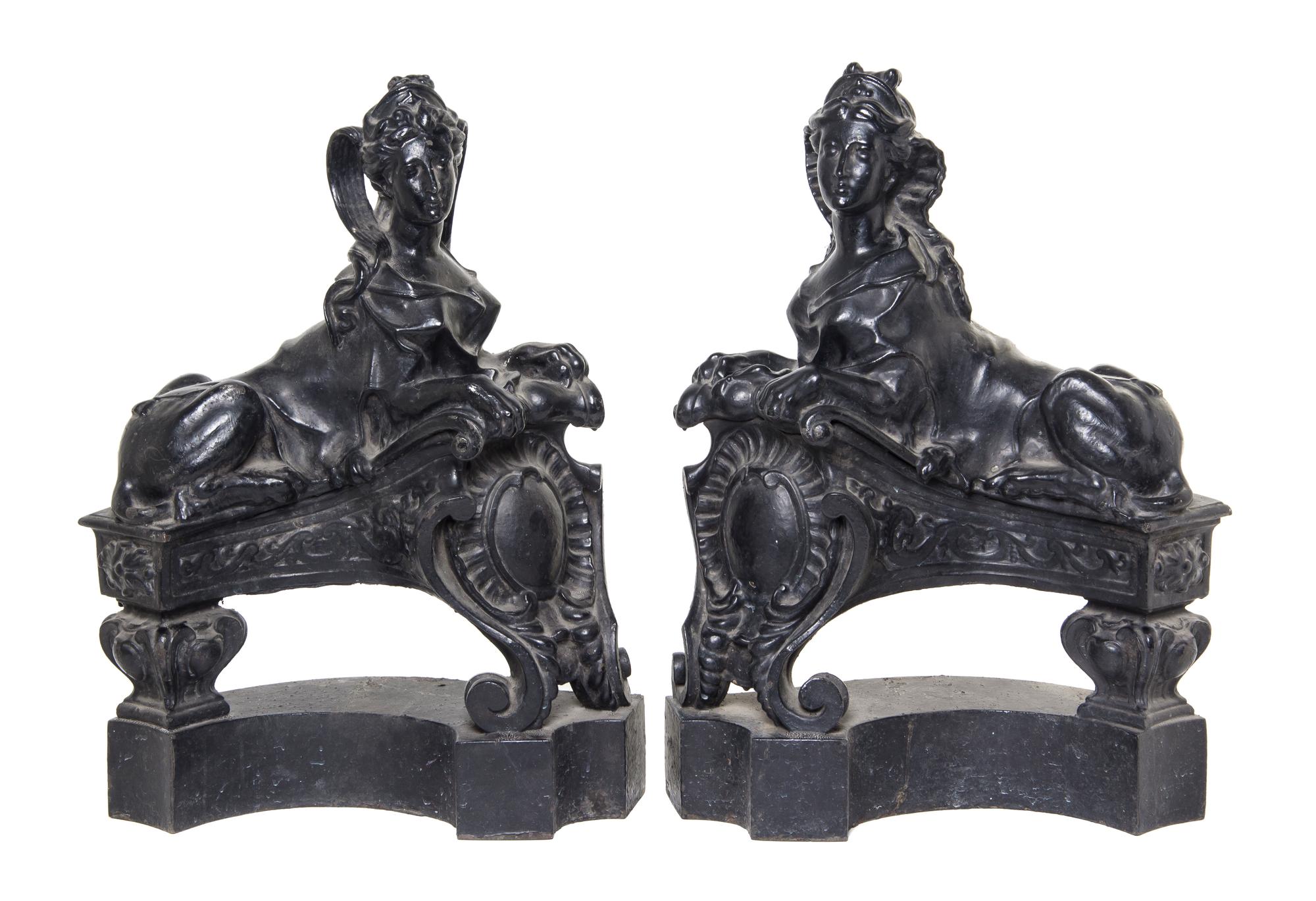 A Pair of English Cast Iron Chenets, Height 21 1/4 inches.