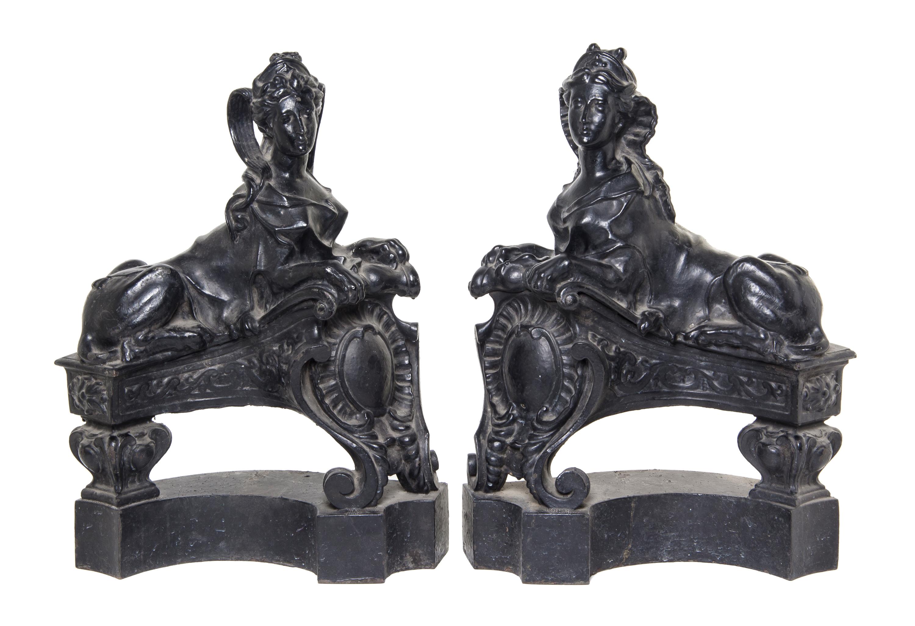 A Pair of English Cast Iron Chenets, Height 21 1/4 inches.
