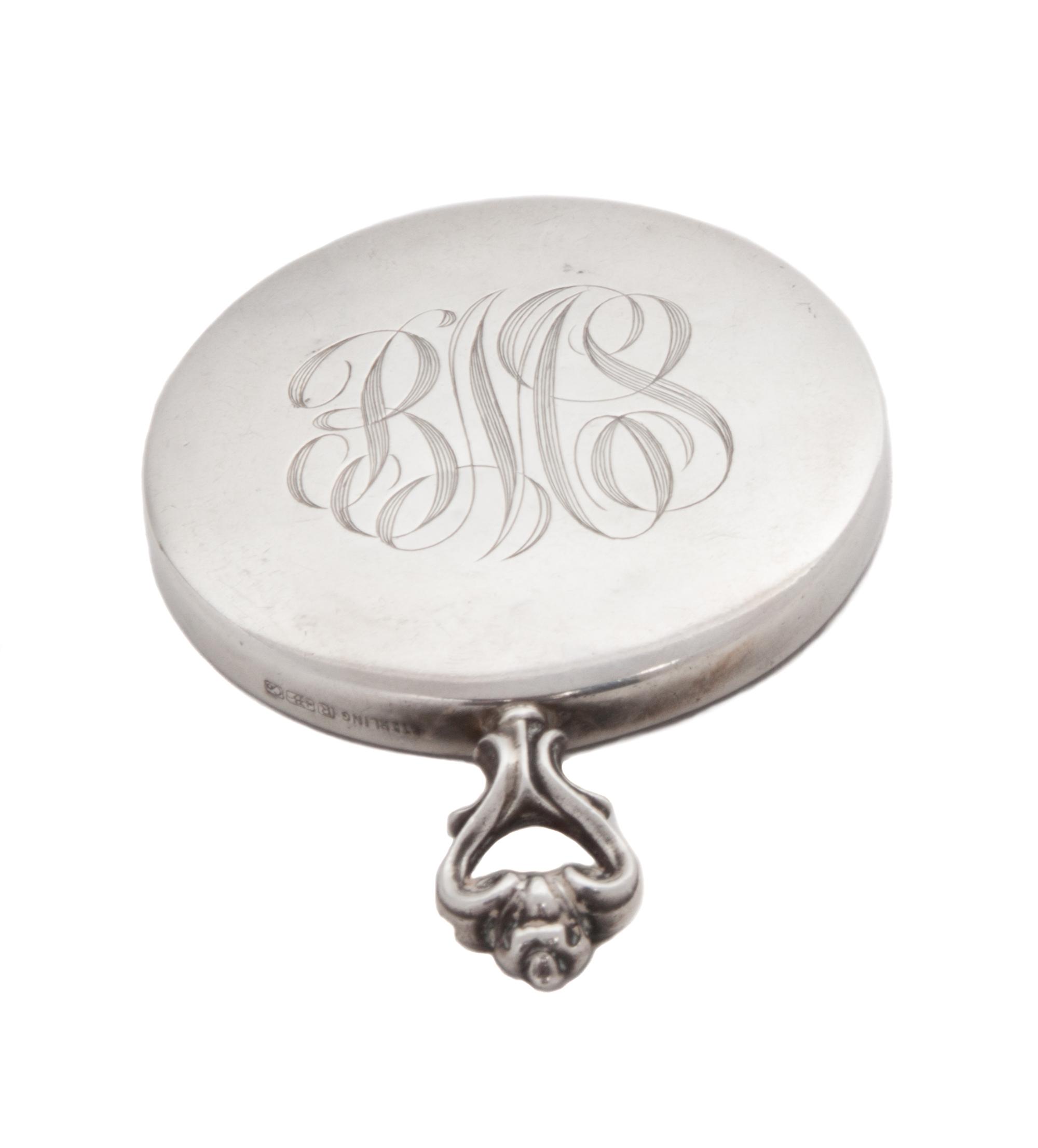 An American Silver Hand Mirror, R. Blackinton & Co., North Attleboro, MA, of circular form with an open handle and script monogram.