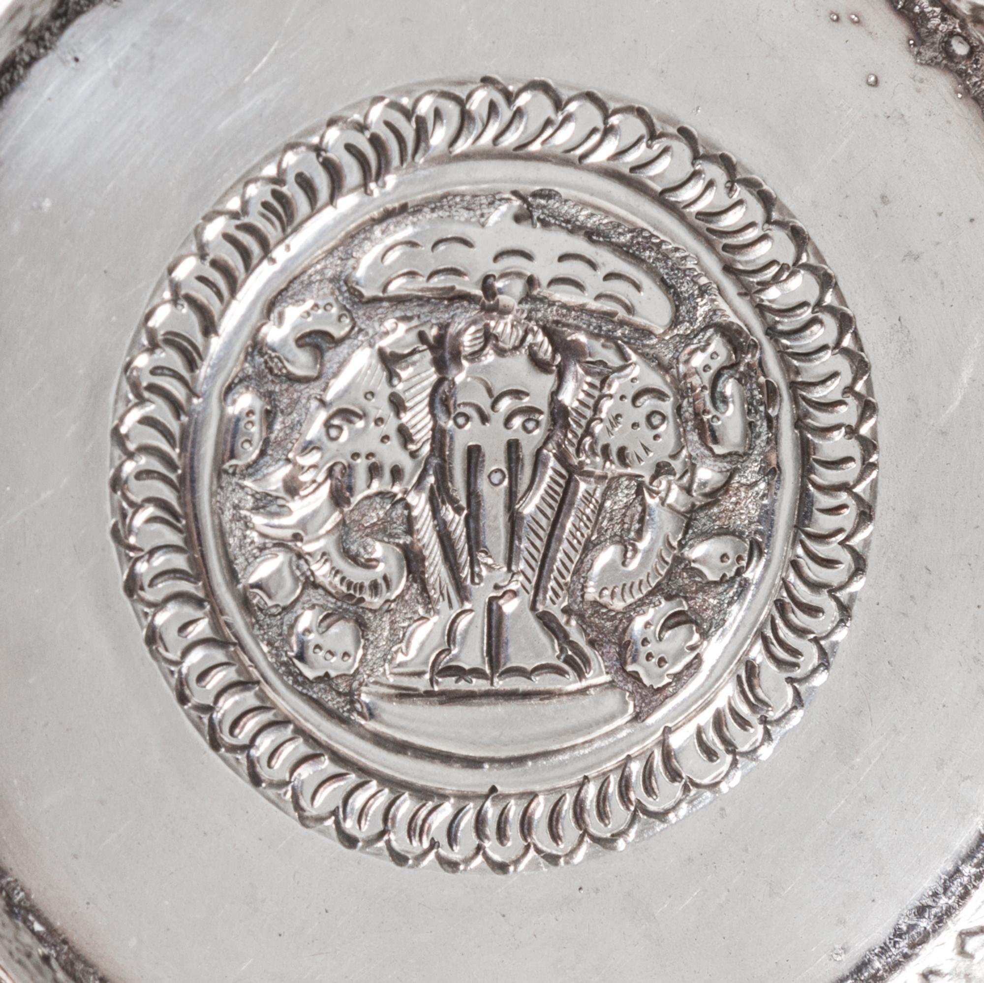 A Silver Box and Cover, Probably Thai, 20th Century, of circular form with allover repeating relief decoration.