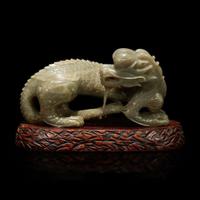 A Chinese carved celadon-grey jade dragon and wood stand 青灰玉龍及木底座