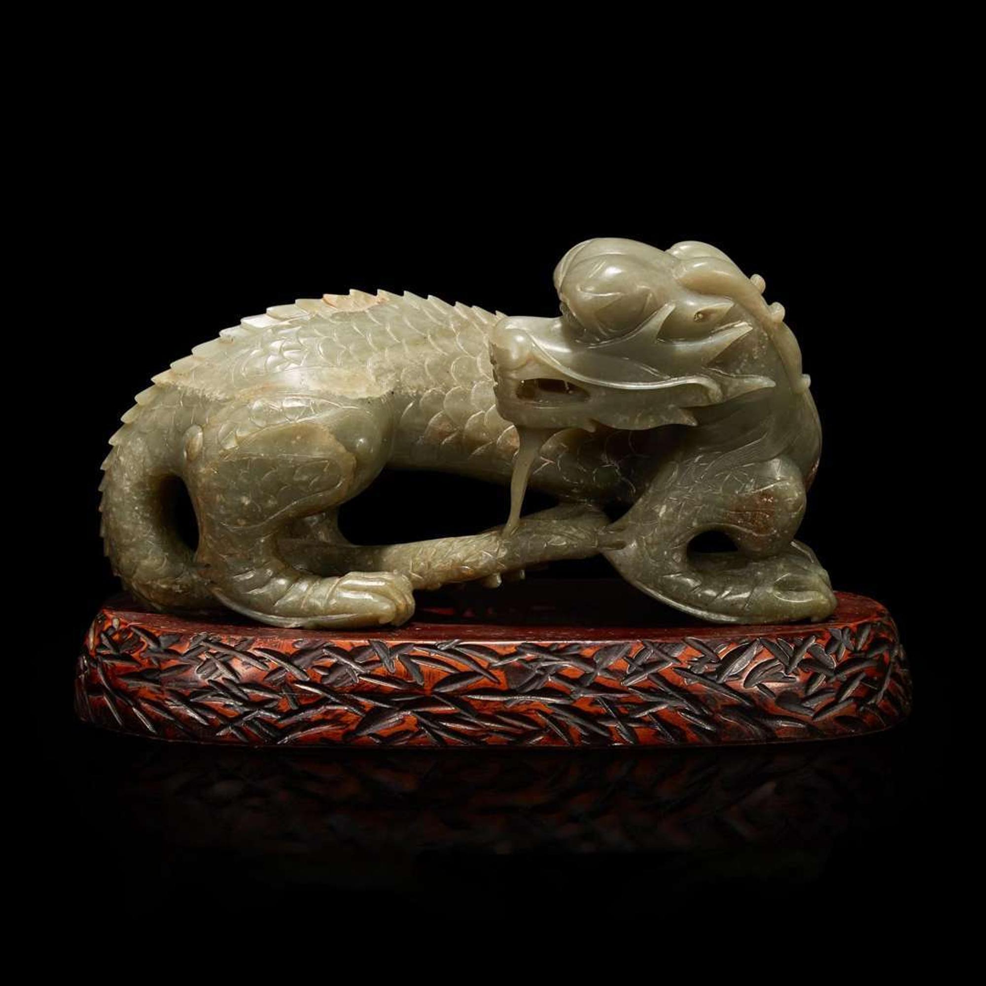A Chinese carved celadon-grey jade dragon and wood stand 青灰玉龍及木底座