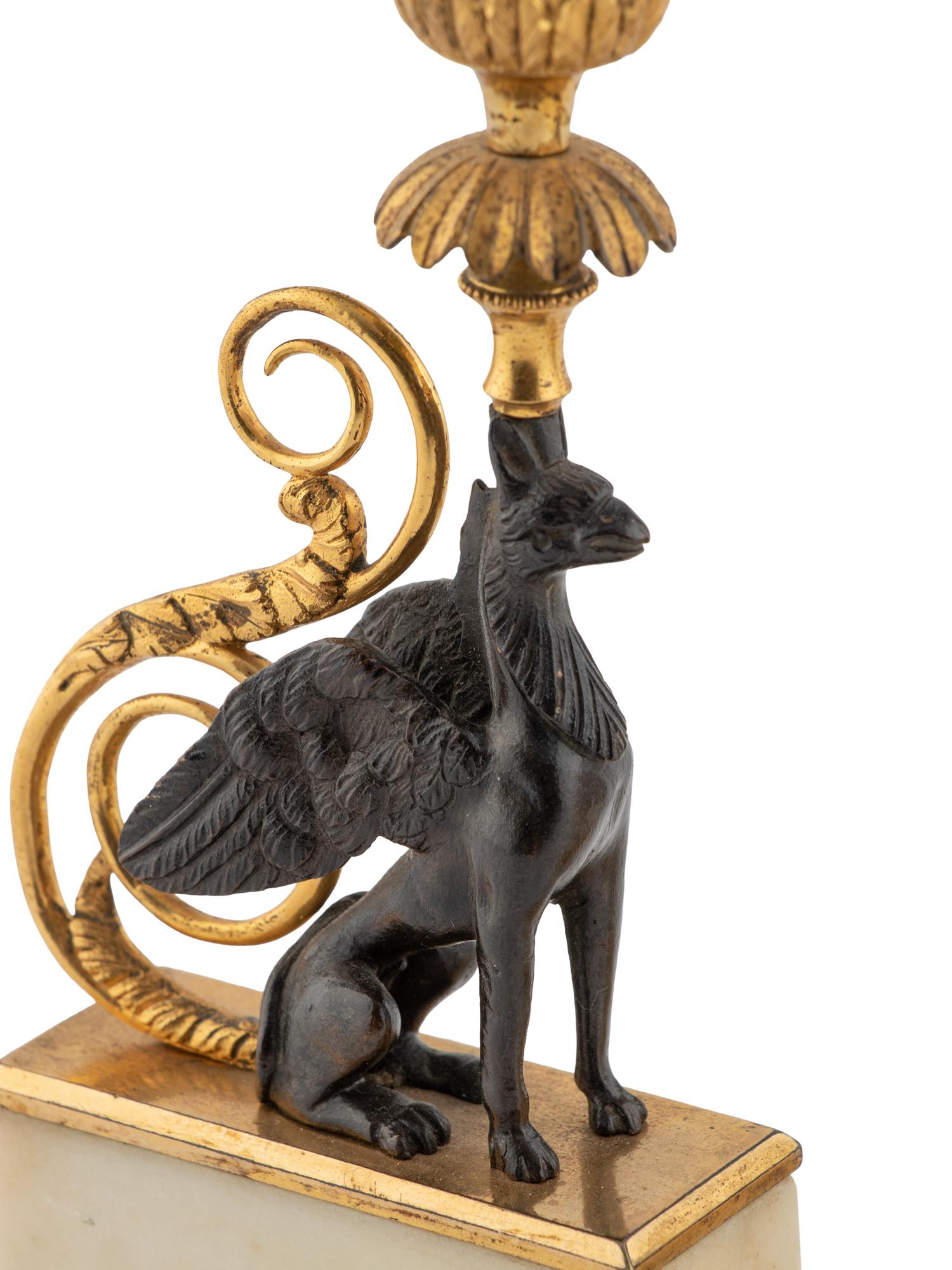 A Pair of Louis Philippe Parcel Gilt Bronze and Marble Griffin Candlesticks