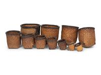 A Set of Eleven Woven and Leather Nesting Baskets