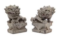 A Pair of Chinese Stone Figures of Buddhist Lions Height of each 10 3/4 inches. — 18TH CENTURY