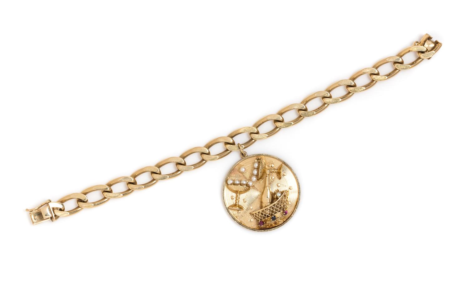 A 14 Karat Yellow Gold Charm Bracelet with Attached Champagne Motif Charm, 35.00 dwts.