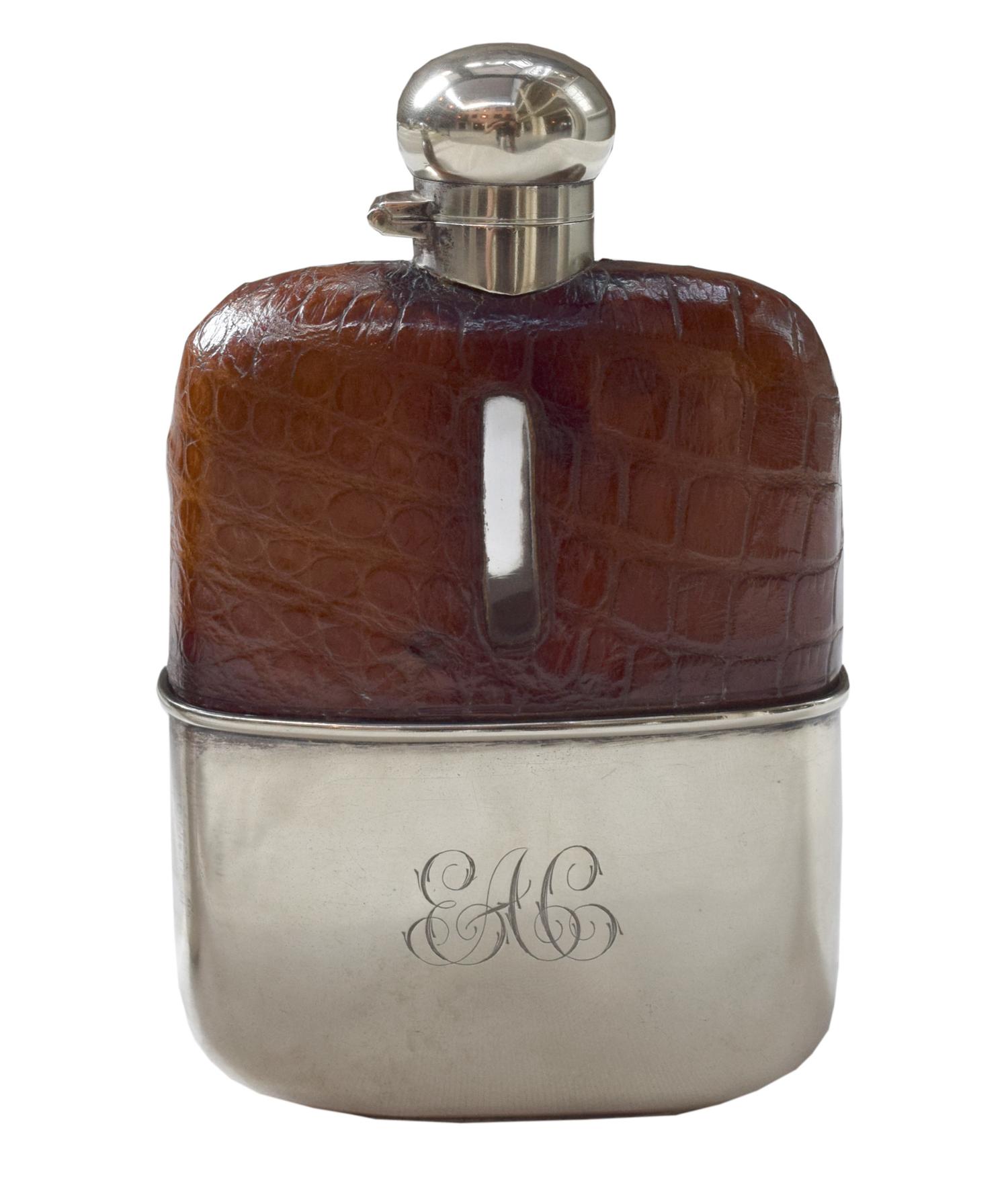 A Set of Three Silver and Stamped Leather Hip Flasks Left: 2.25" x .5" x 3.75" tall: Middle: 3" x 1" x 5" tall: Right: 3.25" x 1" x 5.5 — England, Circa 1925-1940