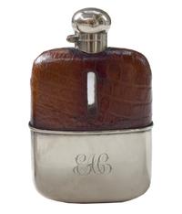 A Set of Three Silver and Stamped Leather Hip Flasks Left: 2.25" x .5" x 3.75" tall: Middle: 3" x 1" x 5" tall: Right: 3.25" x 1" x 5.5 — England, Circa 1925-1940