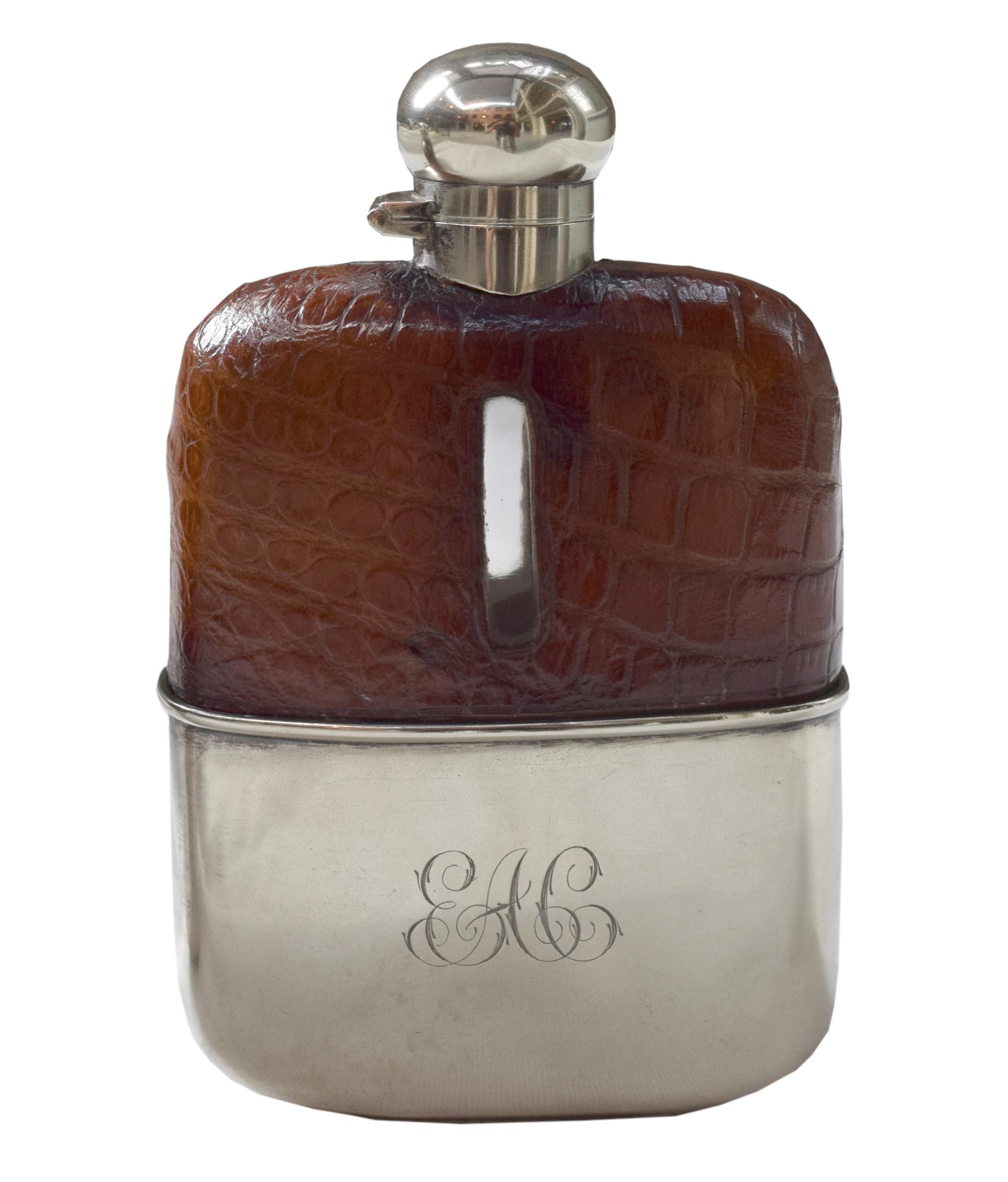 A Set of Three Silver and Stamped Leather Hip Flasks Left: 2.25" x .5" x 3.75" tall: Middle: 3" x 1" x 5" tall: Right: 3.25" x 1" x 5.5 — England, Circa 1925-1940