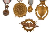 [AMERICANA]. A group of 7 badges identified to Colonial Dames, Daughters of the American Revolution, and other organizations, most 14K gold.
