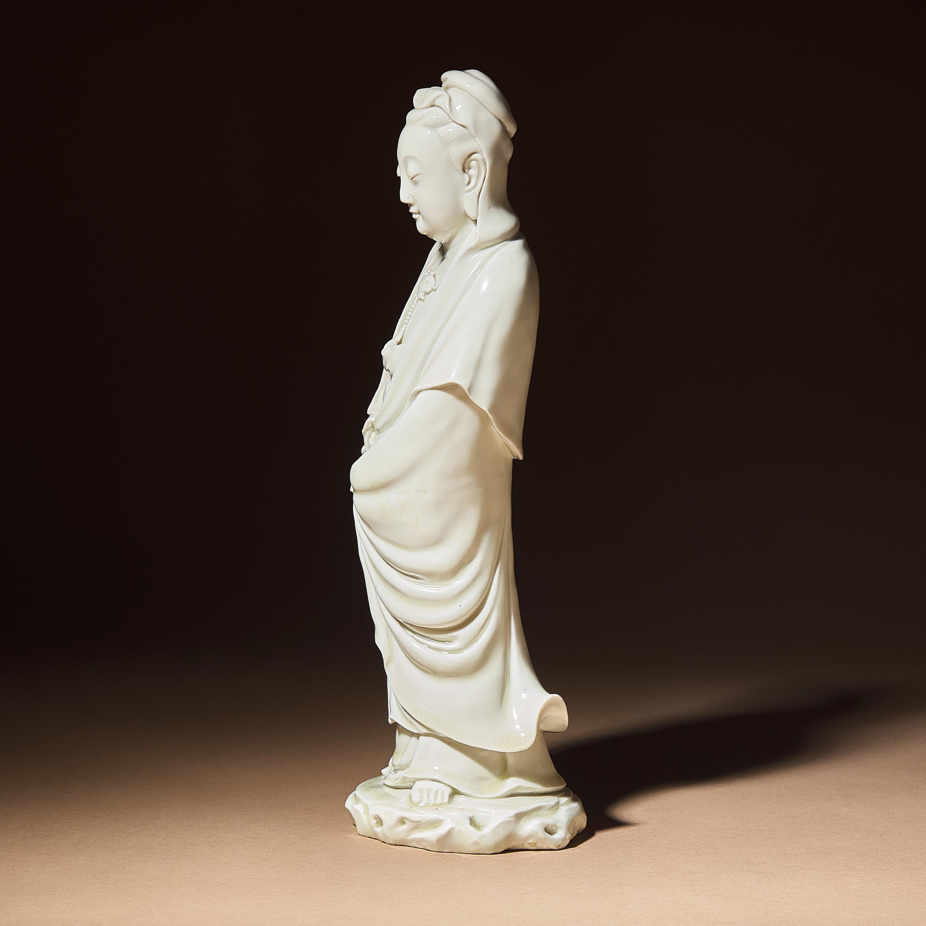 A Chinese Blanc-de-Chine Porcelain Standing Figure of Guanyin with 'He Chaozong' Mark, Qing Dynasty — 清 何朝宗款德化白瓷觀音立像