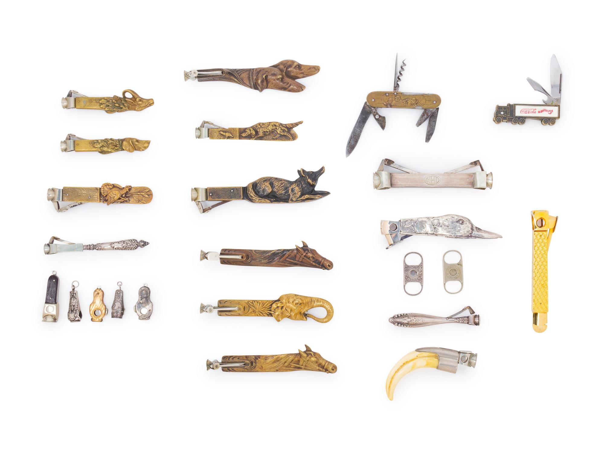 A Group of Twenty-One Brass, Bronze, and Silver Cigar Cutters