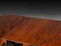 A Late Chippendale Flame Mahogany Triple Pedestal Dining Table