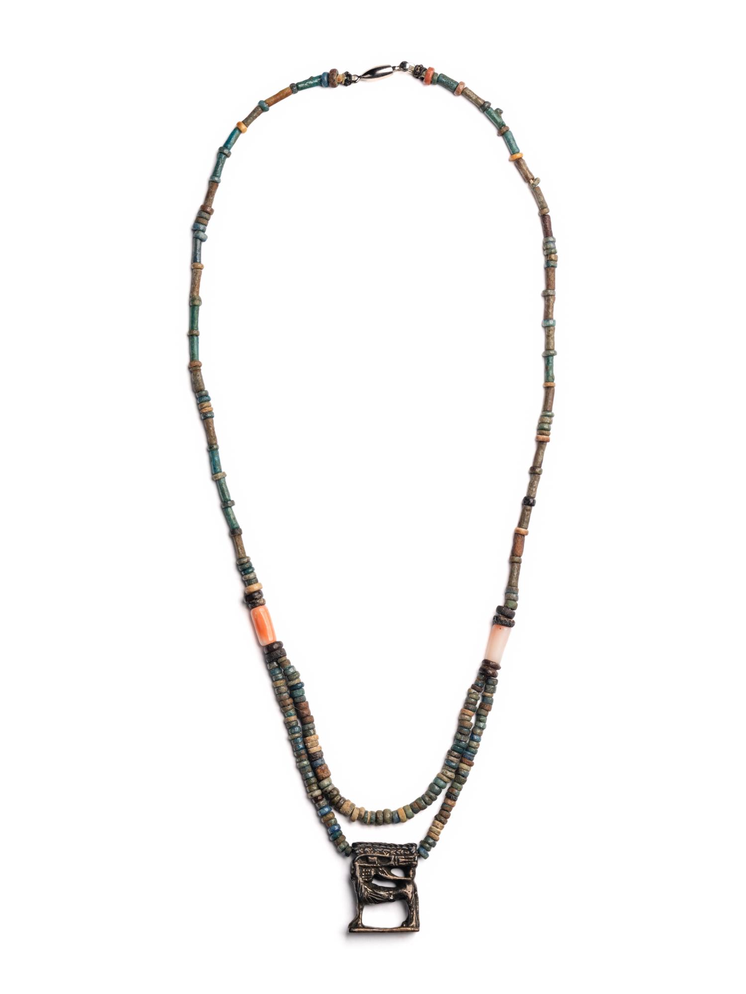 An Egyptian Bead and Faience Necklace with Silver Apis Amulet