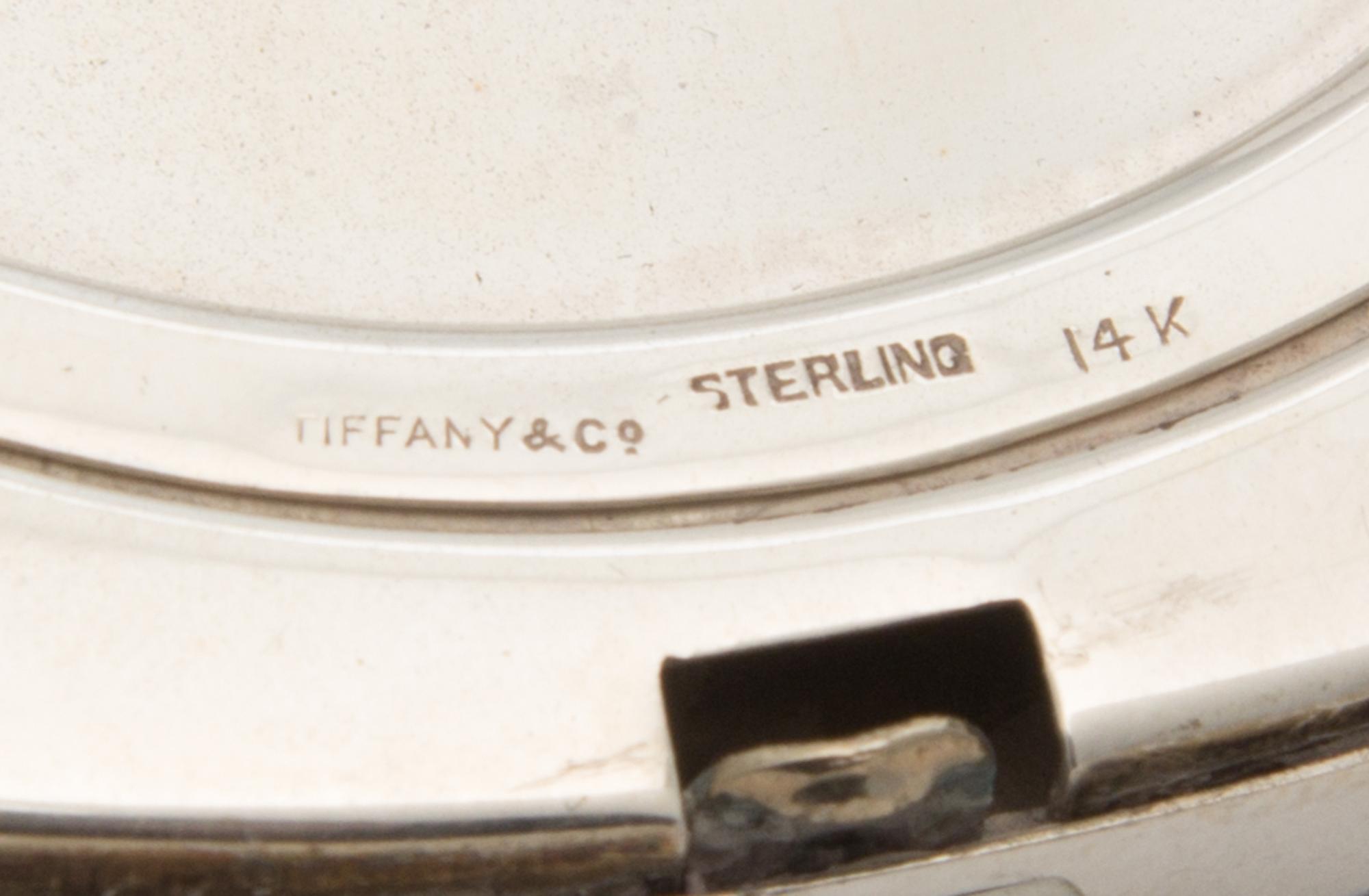 An American Silver, 14-Karat Gold and Ruby Inset Compact, Tiffany & Co., New York, NY, 20th Century, the engine turned lid with an appl