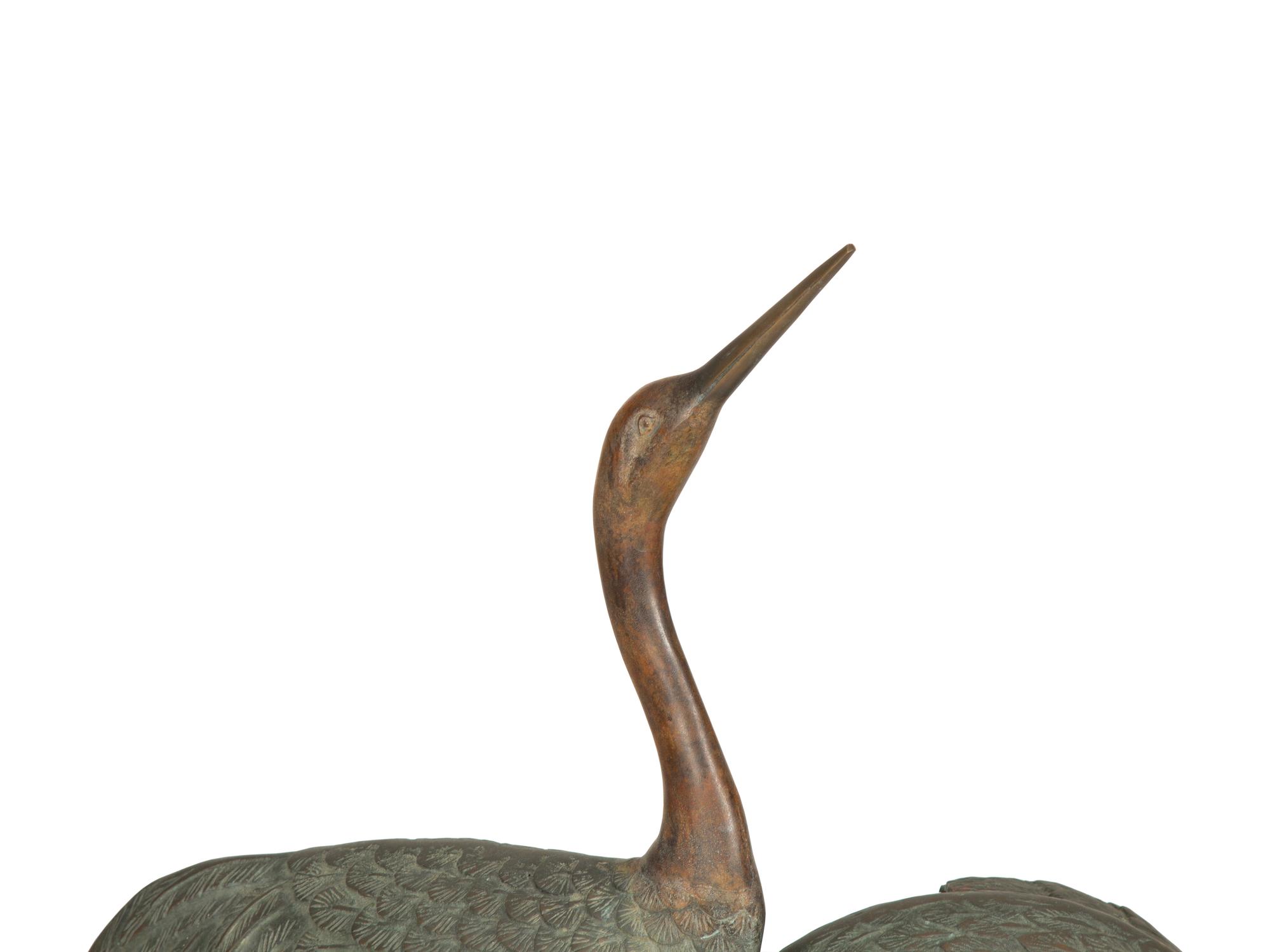 A Bronze Sculpture of Four Standing Cranes