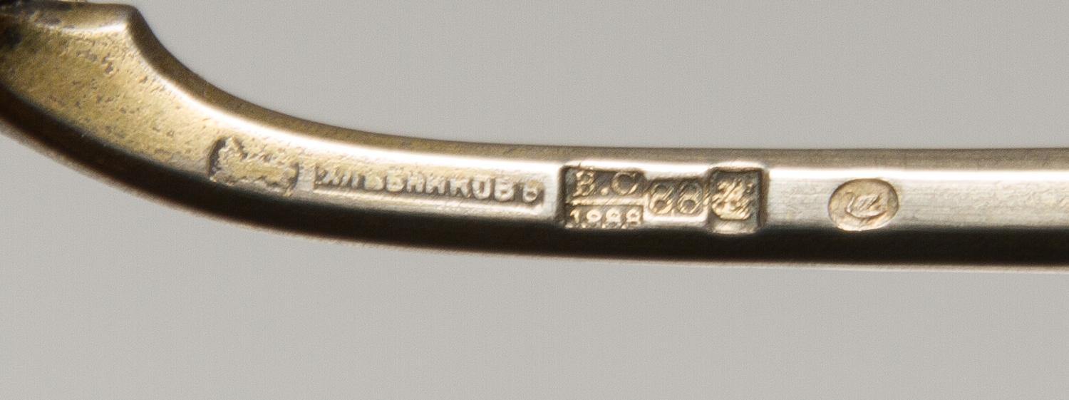 A Russian Silver-Gilt and Enamel Spoon, Mark of Ivan Khlebnikov, assay mark of Viktor Savinsky, Moscow, 1888, having a finial topped ha