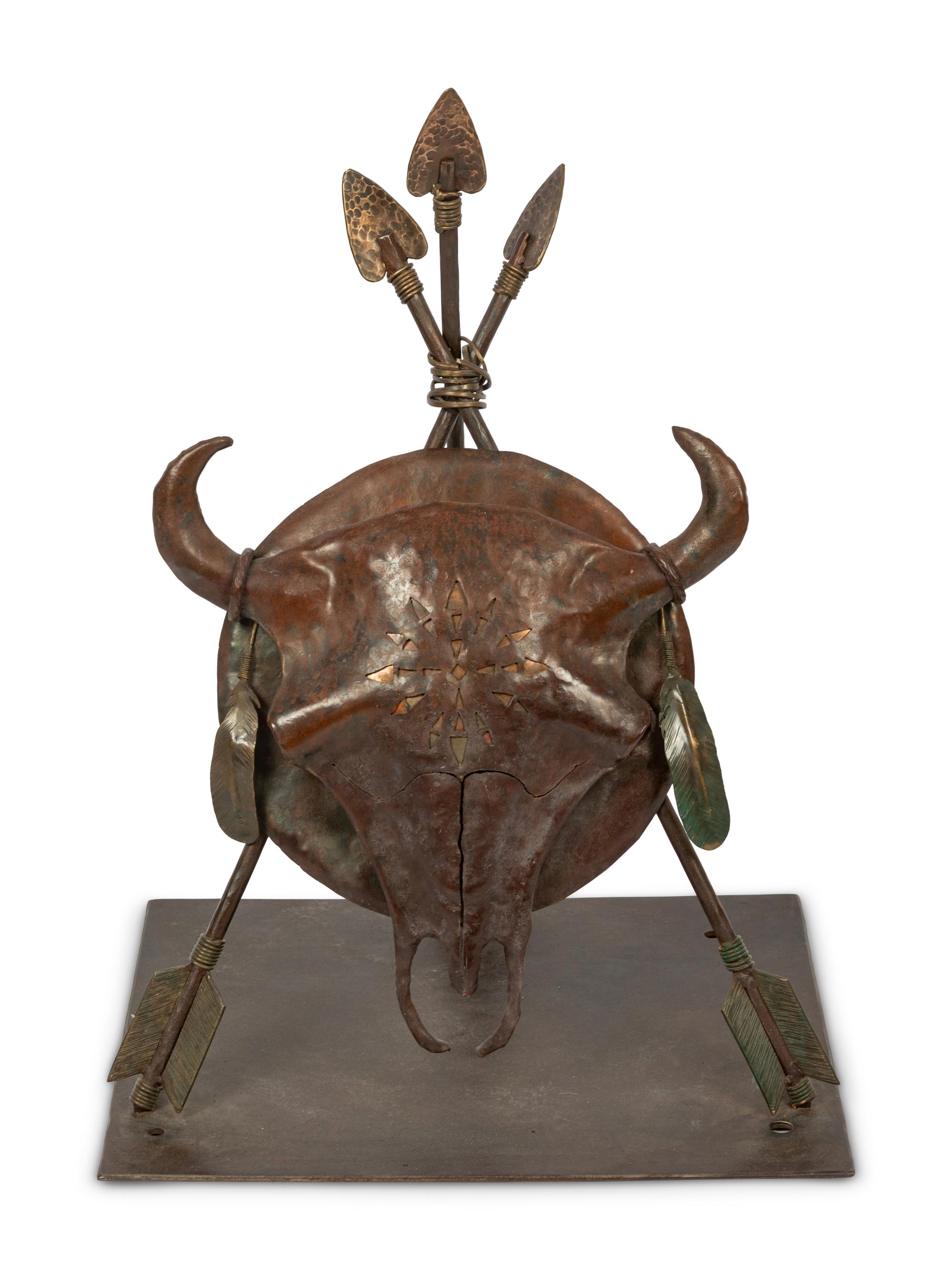 A Bronze Sculpture of a Buffalo Skull Mounted on a Shield and Arrows
