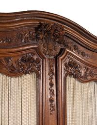 A Louis XV Provincial Style Carved Walnut Armoire