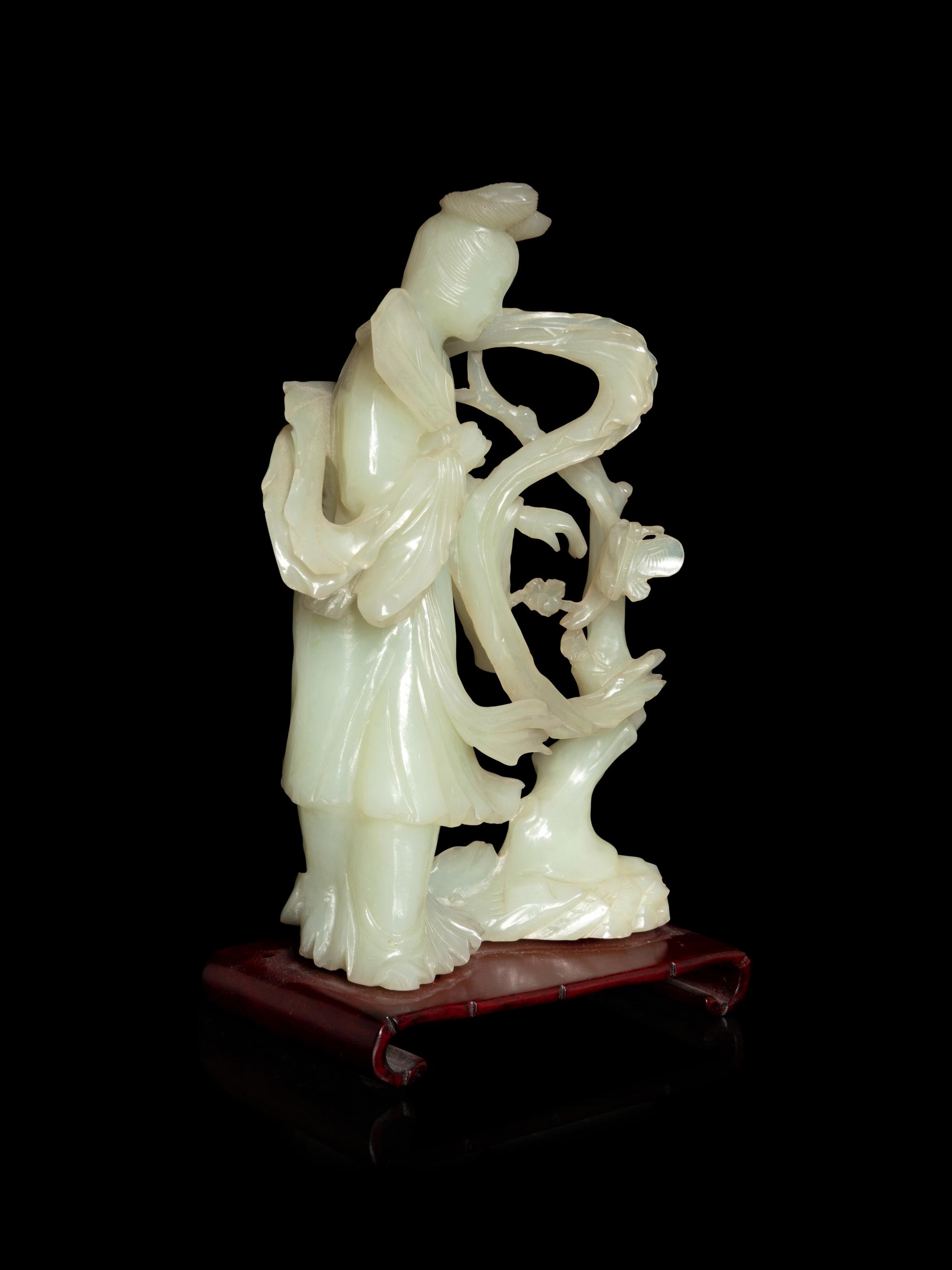 A Chinese Celadon Jade Figure of a Female Immortal