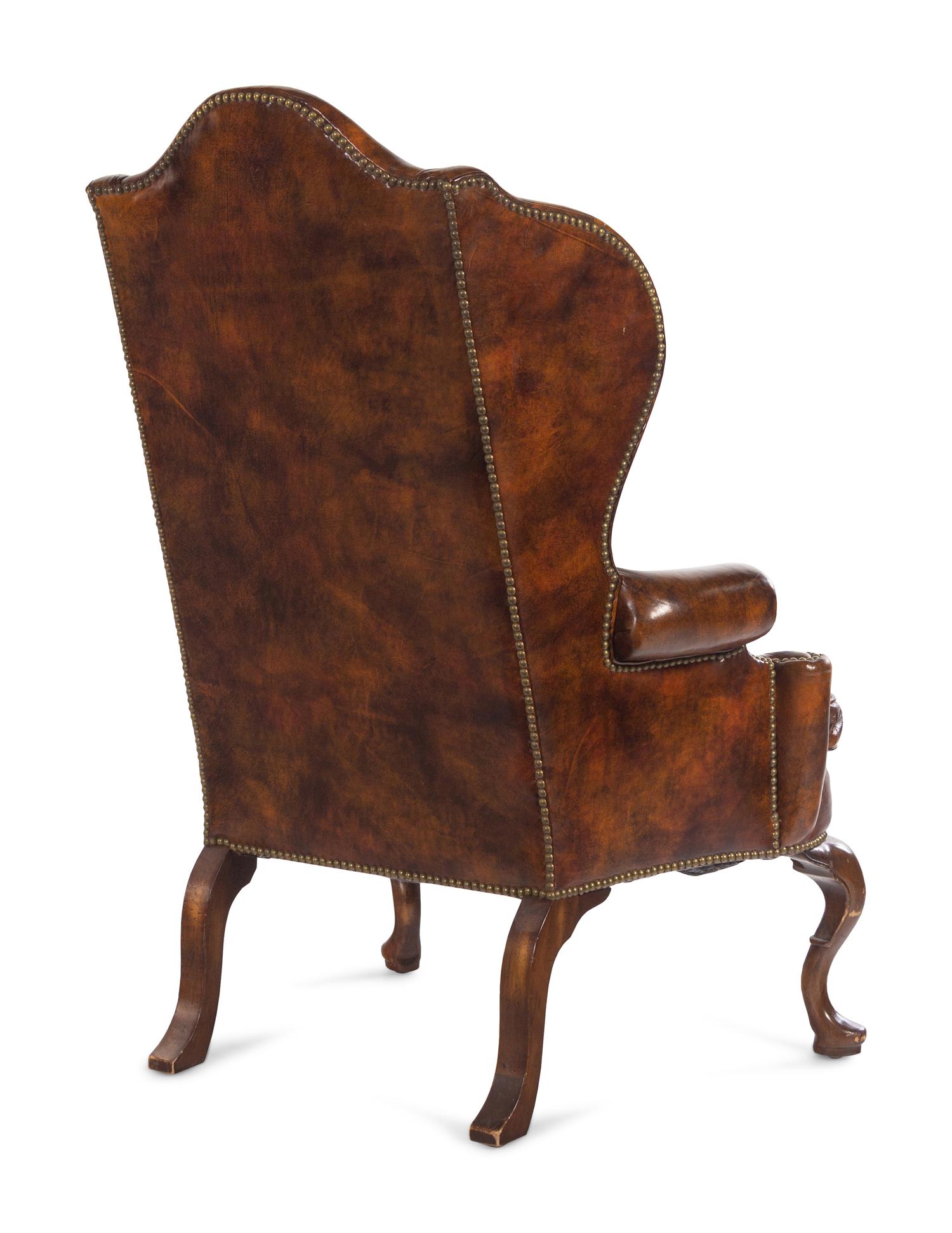 A Queen Anne Style Faux Leather Upholstered Wingback Armchair